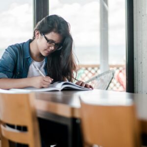 woman writing on book